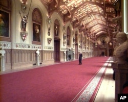 A visitor looks at the ceiling in Windsor Castle's St George Hall, Nov. 17, 1997. Restoration work costing 37 million pounds ($63 million caused by an extensive fire Sept. 9, 1992.