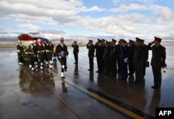 A picture released on Nov. 30, 2015 by Turkish army press office shows Turkish soldiers carry the coffin of Russian pilot Lt. Col. Oleg Peshkov into a Russian Air Force transport during a ceremony at Esenboga Airport in Ankara.
