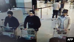 A screengrab of airport CCTV footage released by Belgian federal police shows suspects in the attacks at Brussels Airport, in Zaventem, March 22, 2016. Police is seeking help in identifying the "man in the hat" on the right.