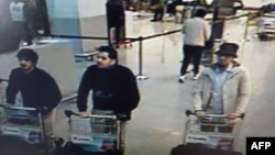 Photo released by Belgian federal police on demand of Federal prosecutor shows screengrab of airport CCTV camera showing suspects of this morning's attacks at Brussels Airport, in Zaventem, March 22, 2016.