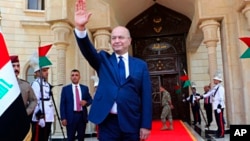 Newly elected Iraq President Barham Salih waves after the inauguration ceremony in Baghdad, Iraq, Oct. 3, 2018. 