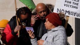 Justin Blake, left, uncle of Jacob Blake, listens to the verdict being read outside the Kenosha County Courthouse, Friday, Nov. 19, 2021 in Kenosha, Wis.