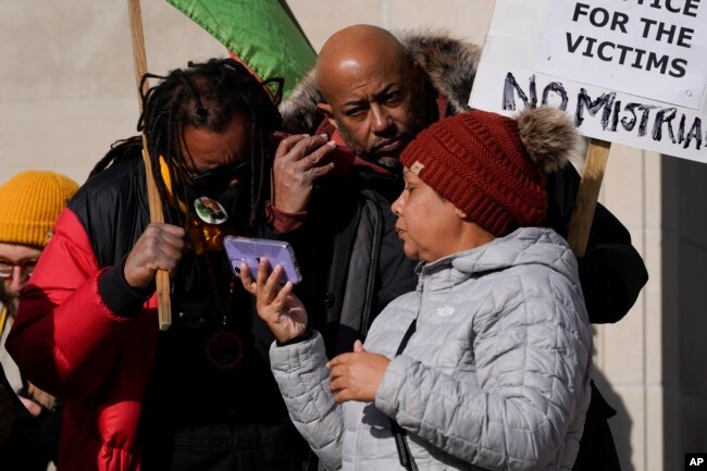 Justin Blake, left, uncle of Jacob Blake, listens to the verdict being read outside the Kenosha County Courthouse, Friday, Nov. 19, 2021 in Kenosha, Wis.