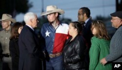 FILE - Vice President Mike Pence and his wife, Karen, talk with first responders, family, friends and victims outside the First Baptist church in Sutherland Springs, Texas, Nov. 8, 2017,