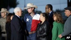 Vice President Mike Pence and his wife, Karen, talk with Johnnie Langendorff, and his girlfriend Summer Caddell, third from right, as they visit with first responders, family, friends and victims outside the Sutherland Spring Baptist Church, Nov. 8, 2017.