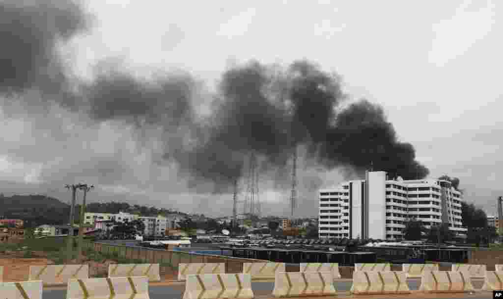 Smoke from the scene of an explosion at a police station is seen after a suspected suicide bomber was killed and many vehicles were destroyed in Abuja June 16, 2011. A suspected suicide bomber was killed and many vehicles were destroyed in an explosion at