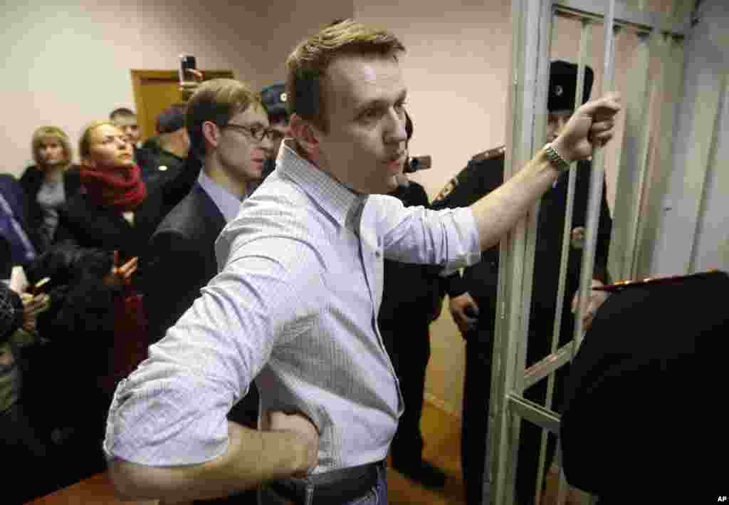 Russian opposition activist and anti-corruption crusader Alexei Navalny, 38, stands at a court in Moscow, Russia, Tuesday, Dec. 30, 2014.