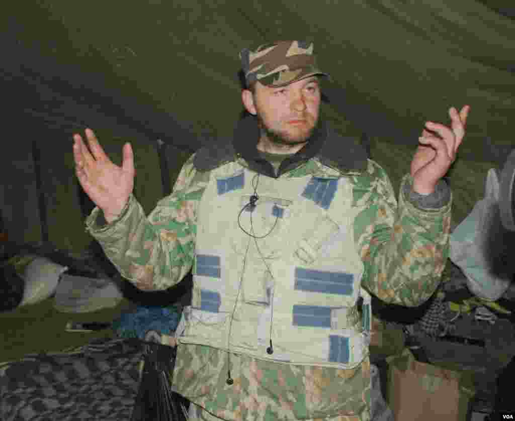 A paramilitary officer shows off the large tent in which he has been living for the past four months in Kyiv's central square. (Steve Herman/VOA)