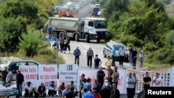 Kosovo war veterans block the road ahead of Serbian President Aleksandar Vucic's planned visit near the village of Banje, Kosovo, Sept. 9, 2018. 