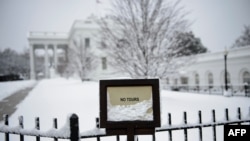 The White House is seen during a winter storm on the 23rd day of the U.S. government shutdown, Jan. 13, 2019, in Washington. 
