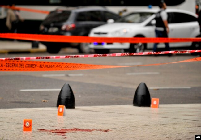 Evidence tent markers mark the crime scene where Argentine lawmaker Hector Olivares was seriously injured and another man was killed after they were shot at from a parked car near the Congress building in Buenos Aires, Argentina, May 9, 2019