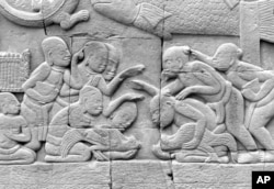 FILE - The old pastime of cockfighting still beguiles enthusiasts in the reliefs carved centuries ago on the walls of the Angkor Wat in Cambodia.