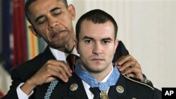 President Barack Obama presents the Medal of Honor to Staff Sgt. Salvatore Giunta, who rescued two members of his squad in October 2007 while fighting in Afghanistan, 16 Nov 2010, at the White House