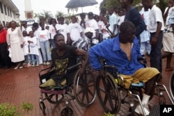 FILE - Two war victims seen in wheelchairs at the launch of Liberia's Truth and Reconciliation Commission in Monrovia, June 22, 2006. An accounting of atrocities committed during nearly a quarter-century was aimed at setting the stage for a long-term peace.