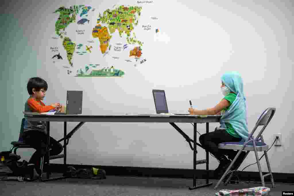 Alondra and Hendi, both six-years-old, take their zoom class as the Westchester Family YMCA during the outbreak of COVID-19 in Los Angeles, California, March 2, 2021.