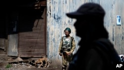 Indian paramilitary soldiers stand guard during a curfew in Srinagar, Indian controlled Kashmir, Friday, July 29, 2016.