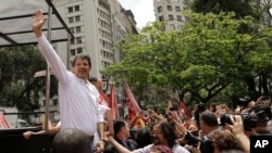 Sao Paulo's Mayor Fernando Haddad, of the Workers Party, greets supporters as he campaigns for re-election in Sao Paulo, Brazil, Sept. 30, 2016. 