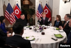 U.S. President Donald Trump and North Korean leader Kim Jong Un sit down for a dinner during the second U.S.-North Korea summit at the Metropole Hotel in Hanoi, Vietnam Feb. 27, 2019.