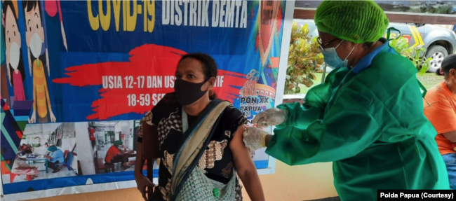 Warga Kampung Demta, Jayapura, Papua, hari Minggu (11/7) divaksinasi oleh tim kesehatan Polsek Demta, Polres Jayapura. (Courtesy: Polda Papua)