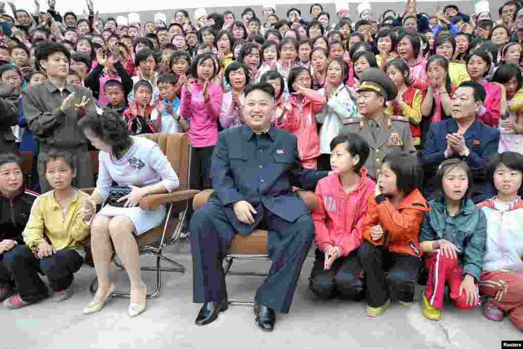 North Korean leader Kim Jong-un (C) and his wife Ri Sol-ju during a visit to the Pyongyang Myohyangsan Children's Camp situated at the foot of Mt. Myohyang in North Phyongan Province, in this photo released by North Korea's Korean Central News Agency (KCNA)