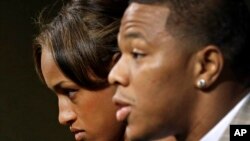FILE - Janay Rice, left, looks on as her husband, Baltimore Ravens running back Ray Rice, speaks to the media during a news conference in Owings Mills, Md.