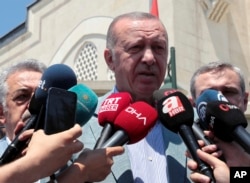 FILE - Turkish President Recep Tayyip Erdogan speaks to the media after Friday prayers, in Istanbul, June 7, 2019.