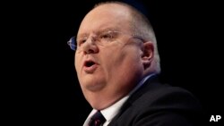 FILE - Eric Pickles, Secretary of State for Communities and Local Government, speaks at Britain's Conservative Party Conference in Manchester, England, Oct. 3, 2011. 