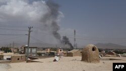 Smoke rises into the air after Taliban militants launched an attack on the Afghan provincial capital of Ghazni, Aug. 10, 2018.