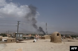 Smoke rises into the air after Taliban militants launched an attack on the Afghan provincial capital of Ghazni, Aug. 10, 2018.