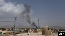 FILE - Smoke rises into the air after Taliban militants launched an attack on the Afghan provincial capital of Ghazni, Aug. 10, 2018.