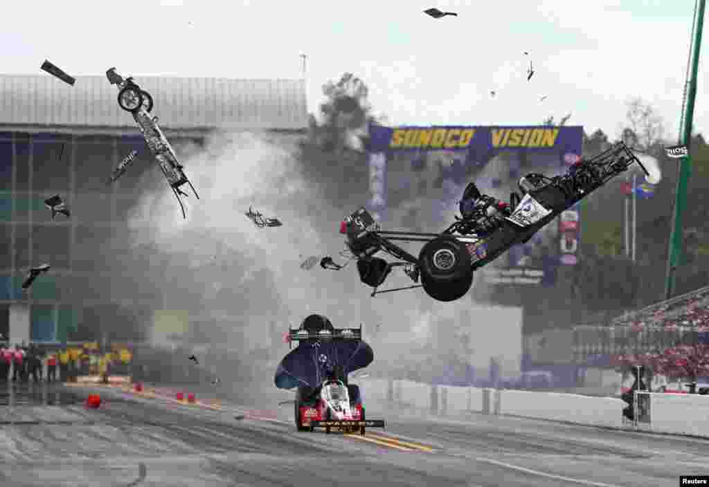 NHRA top fuel dragster driver Larry Dixon (right) crashes and goes airborne alongside Doug Kalitta after his car broke in half during qualifying for the Gatornationals at Auto Plus Raceway at Gainesville, Florida, USA. Dixon walked away from the incident. (Credit: Mark J. Rebilas/USA TODAY Sports)