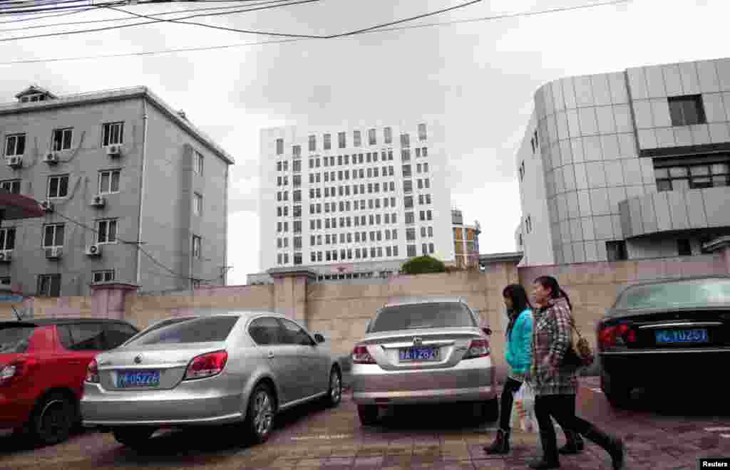 People walk past Unit 61398 in Shanghai February 19, 2013, the unit believed to be behind a series of hacking attacks.