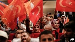 Supporters of Turkey's President and ruling Justice and Development Party leader Recep Tayyip Erdogan wave flags as they listen to him speak during an election rally in Istanbul, Turkey, May 29, 2018.