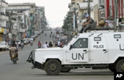 United Nations [UN] peacekeepers patrol in their vehicle during Liberia's presidential election run-off, along a street in Monrovia, Liberia, November 8, 2011.