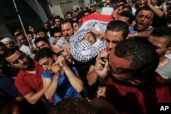 Palestinians carry the body of Mohammed Abu Hashhashi, 17, during his funeral in the West Bank refugee camp Fawwar, near the West Bank city of Hebron, Wednesday, Aug. 17, 2016. Abu Hashhashi was killed by live fire during clashes between Israeli troops and Palestinians the day before.