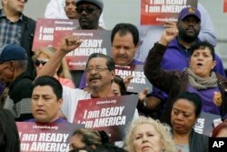 FILE - Community activists rally during an event on Deferred Action for Childhood Arrivals, DACA and Deferred Action for Parental Accountability, DAPA in downtown Los Angeles, California, Feb. 17, 2015.