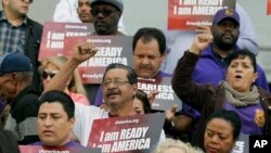 FILE - Community activists rally during an event on Deferred Action for Childhood Arrivals, DACA, and Deferred Action for Parental Accountability, DAPA, in Los Angeles, Feb. 17, 2015.