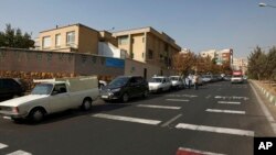 Cars wait in line to fill up at a gas station because pumps machines are out of service, in Tehran, Iran, Oct. 26, 2021.