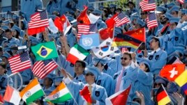 Students in the School of International and Public Affairs wave flags at Columbia University's commencement, Wednesday, May 22, 2019 in New York. More than 14,000 undergraduate and graduate students at the university have completed their studies. (AP Phot