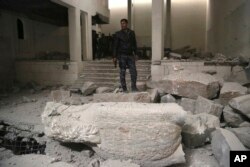 Iraqi federal police inspect the inside of Mosul's heavily damaged museum, March 8, 2017. Two Iraqi archaeologists confirmed that many of the artifacts destroyed by IS were the original ancient stone statues dating back thousands of years.