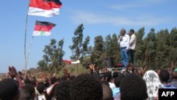 FILE - Merara Gudina, top left, the chairman of the Oromo people's Congress addresses a crowd of supporters during a political rally in in his home town of Tokkee, May 15, 2010. 