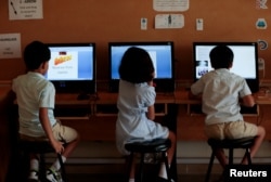 Students use computers in the technology lab at the Headstart private school in Islamabad, Pakistan, Oct. 9, 2017.