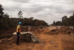 In this August 2020 photo, a construction worker is seen at the Ngong Road site in Nairobi. Challenges with the project have included delays from COVID-19 and issues with moving water and power lines. (Kang-Chun Cheng/VOA)