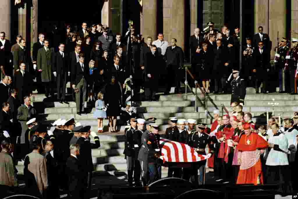 Representatives of all branches of the military act as pall bearers during the funeral of President John F. Kennedy as they leave following funeral services at St. Matthew's Cathedral in Washington, Nov. 25, 1963. 