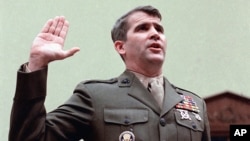 In this Dec. 18, 1986 file photo, NSC staffer Oliver North is sworn in on Capitol Hill in Washington prior to testifying before the House Foreign Affairs Committee.