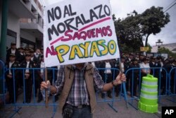 Un manifestante en Ciudad de Guatemala sostiene un cartel contra el presidente Jimmy Morales, mientras el mandatario entregaba su balance del año al Congreso. Lunes 14 de enero de 2019.