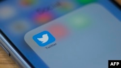The Twitter logo is seen on a phone in this photo illustration in Washington, DC, on July 10, 2019. (AFP)