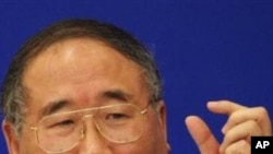 China's top climate change negotiator, Xie Zhenhua, gestures as he answers a question during a press conference, inside the Great Hall of the People in Beijing (File Photo)