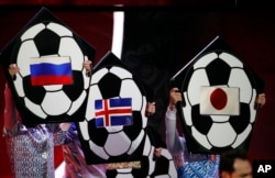 The flags of Russia, Iceland and Japan are held up on placards during the 2018 soccer World Cup draw in the Kremlin in Moscow, Dec. 1, 2017.