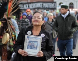 FILE - Lynn Eagle Feather, Lakota, takes part in a protest demonstration against the police shooting of her son Paul Castaway in Denver, Colorado, in July 2015.